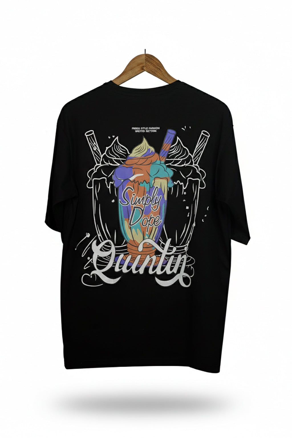 Black t-shirt with colorful graphic design on a hanger against a white background