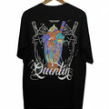 Black t-shirt with colorful graphic design on a hanger against a white background